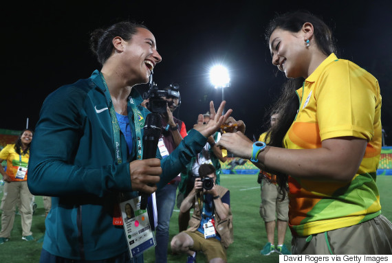 RIO DE JANEIRO, BRAZIL - AUGUST 08: Volunteer Marjorie Enya (R) proposes marriage to rugby player Isadora Cerullo of Brazil after the Women's Gold Medal Rugby Sevens match between Australia and New Zealand on Day 3 of the Rio 2016 Olympic Games at the Deodoro Stadium on August 8, 2016 in Rio de Janeiro, Brazil. (Photo by David Rogers/Getty Images)